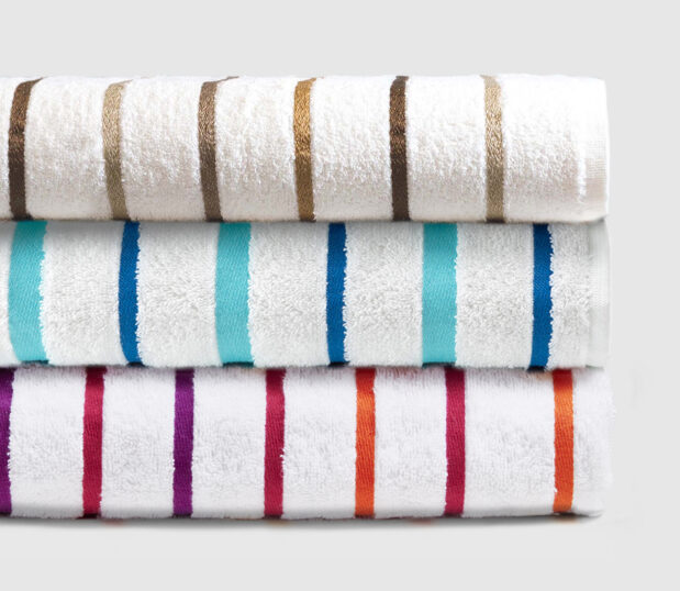 A stack of our complete collection of premium striped pool towels.