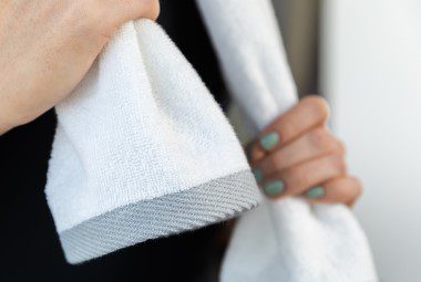 Woman holding a fitness towel while exercising.