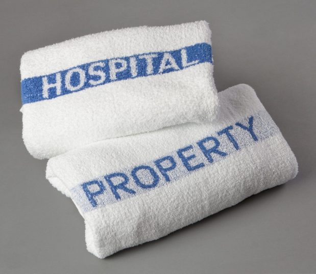 Our Excel® Hospital Property bath towels are shown in a stack. These white hospital towels are hardworking and still soft.