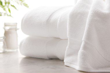 Hotel towels resting on a countertop