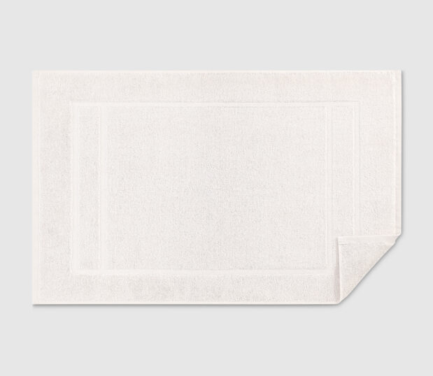 Mystique bath mat shown flat with one corner flipped up.
