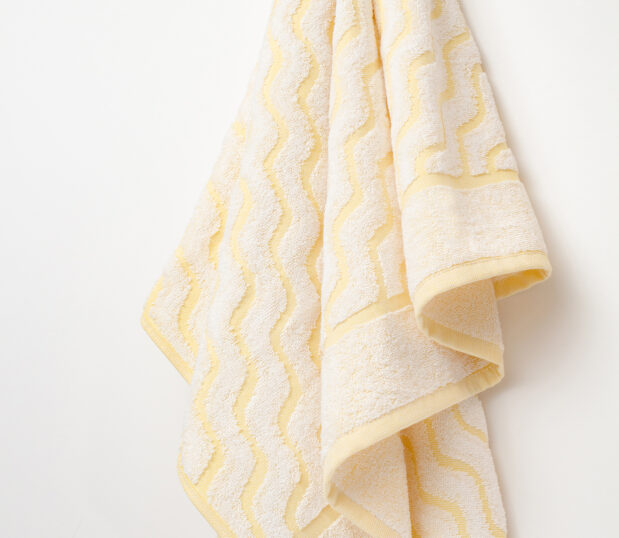 A hanging shot of our EuroSpa Wave Yellow towel