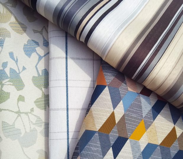 A variety of fabric swatches are artfully arranged.