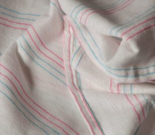Our PerVal® Receiving Blankets feature the recognizable pink-blue stripes it is shown here folded to show the stripes. This image of the baby blanket shows the white version.