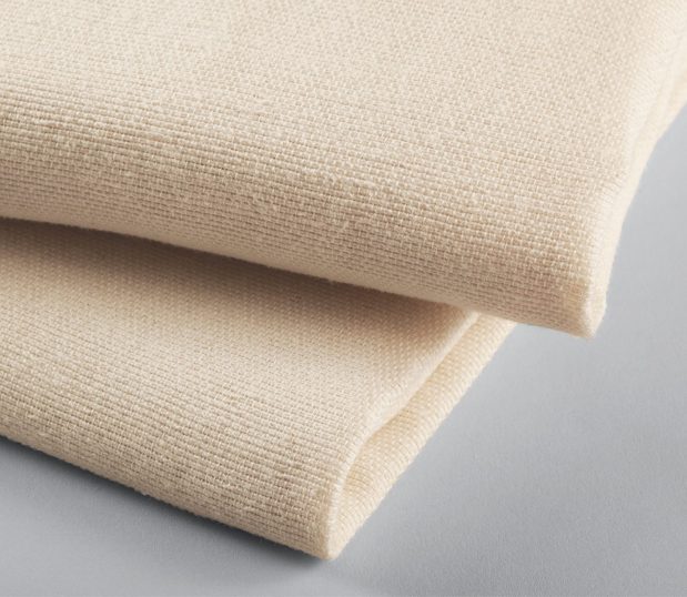 A stack of two PerVal Bath Blankets shown in the natural color.