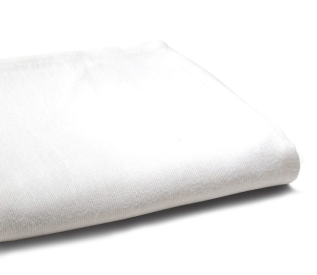 A white Super Daydream bath blanket is folded and shot at an angle.