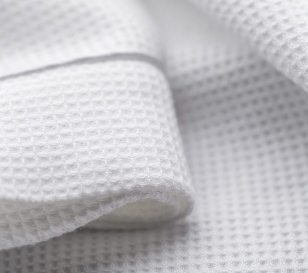 Detail of the waffle spa robe showing the finely woven waffle texture.