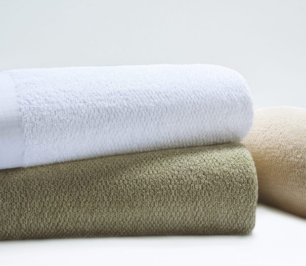 The Dual Cover® Blanket is shown here stacked. Three of the colorways are shown here. These hospital blankets are available in bleached white or 7 different vat dyed color options.