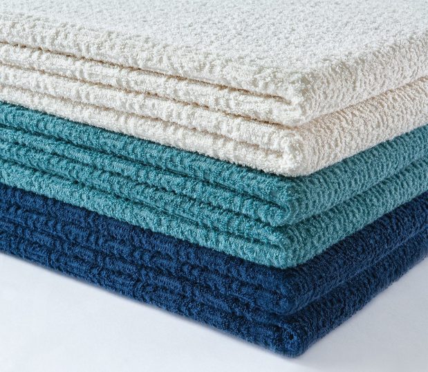 A stack of Insulite® Blankets in three of the available colorways. This is a patented STC exclusive hospital blanket.