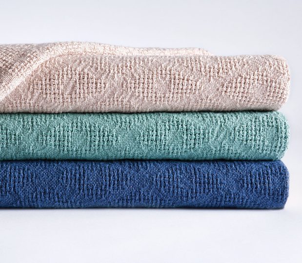The Thermo Plus® Spread Blanket with it's distinguished woven diamond pattern shown here folded and stacked.