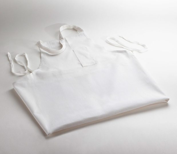 This bib apron features a chest pocket for pens or glasses.