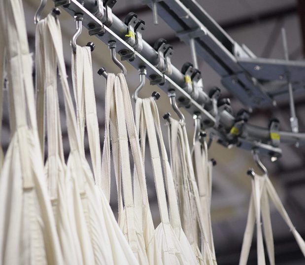 Image shows laundry hanging in a laundry facility. ControlTex LBS Laundry Business Systems streamlines your process for laundry operations.