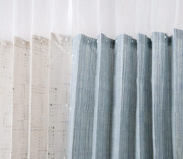 Two Disposable Privacy Curtains with Snap Off Panels shown hanging from a track.