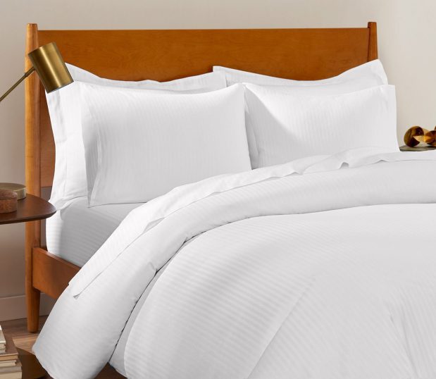 This subtly striped duvet cover delivers hotel quality comfort and durability. A ComforTwill® duvet cover will stay bright and soft, wash after wash. Shown here: a close up view of a duvet on a bed.