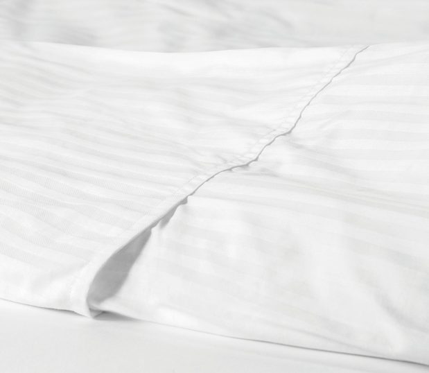 This subtly striped duvet cover delivers hotel quality comfort and durability. Shown here: a detail shot of a designer closure ComforTwill duvet.