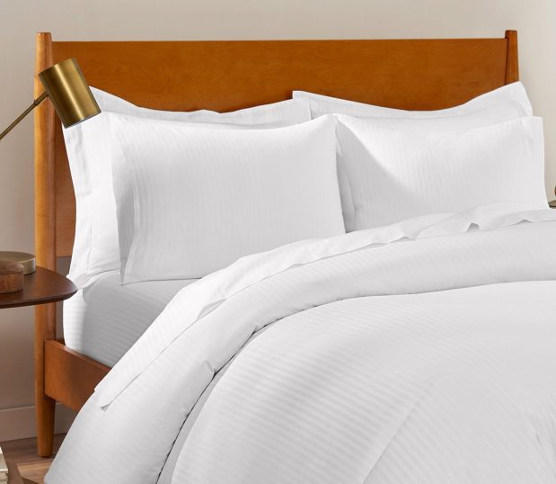Image shows ComforTwill duvet and pillow shams on a bed.