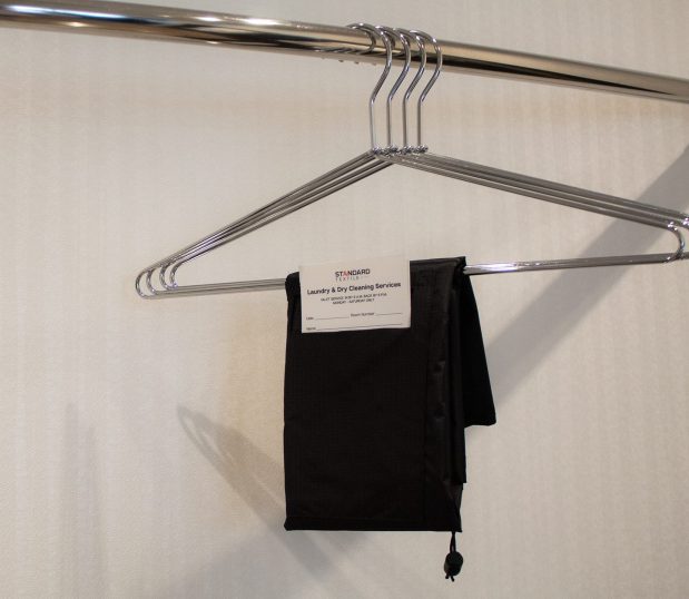 Made from 100% recycled polyester, the VersaValet™ features an antimicrobial finish for added protection and peace of mind. Image shows the VersaValet Hybrid Garment & Laundry Bag folded to its smallest size on a hanger.