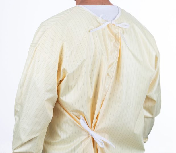 Back view of our reusable isolation gown.It is pale yellow with white ties at neck and waist.