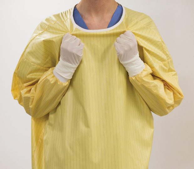 Front view of the EasyRelease® Isolation Gowns. Shown here is a person easily removing the gown by themself.