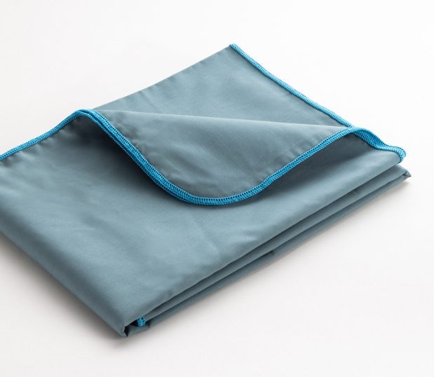 Folded image of the Standard Supreme Surgical Wrappers in Ceil. The the color of the merrowed edge indicates the size of the drape.