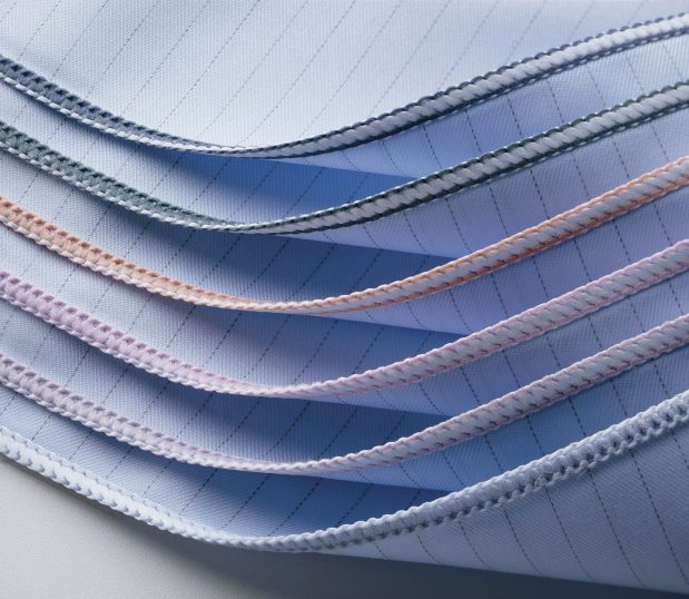 Six of the Blue WraPel® SingleWrap® Surgical Wrappers are stacked to show their merrowed edges. The different colored edges indicate the size of the wrapper.