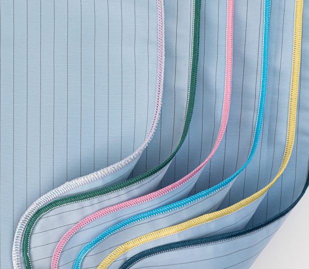 Six of the WraPel® SingleWrap® Surgical Wrappers are stacked and folded to show the merrowed edges. These surgical wrappers are dual-ply so you only need one instead of two.