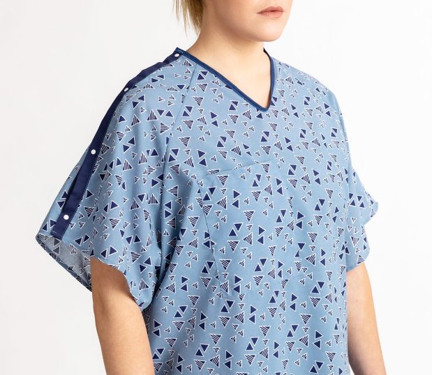 This is a detail front view of the Keystone E*Star® Patient Gown. This image of the hospital gown features the plastic snap I.V. sleeves and telemetry pocket.