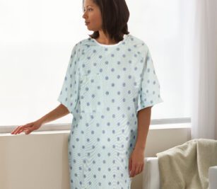 Patient wearing a Lapover Patient Gown. These hospital gown are made from various fabrics and colors to suit a range of needs.