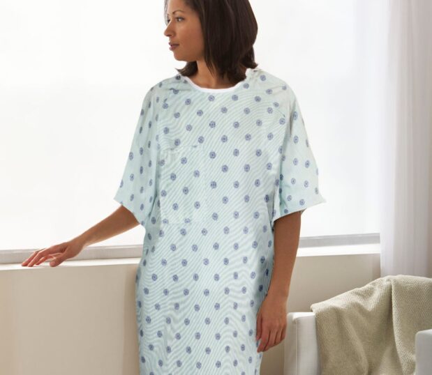 Patient wearing a Lapover Patient Gown. These hospital gown are made from various fabrics and colors to suit a range of needs.