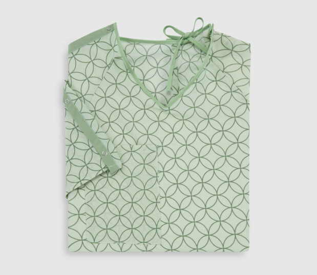 Folded EStar patient gown in Motif Green. This gown is lapover design with IV sleeves and a telemetry pocket.