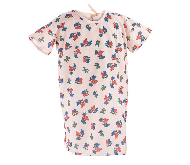 Silhouette of our Pediatric Hospital Gowns with a lapover design made from ChildGuard™ Fabric. This pediatric hospital gown has the Happy Hound print in Coral.