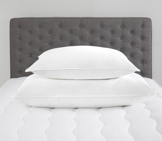 Image shows two Chamberfirm pillows stacked on a mattress.