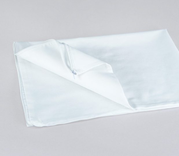 Find affordable, no-frills protection with this no-iron pillow cover. Image shows a folded no-iron pillow cover with an end zipper.