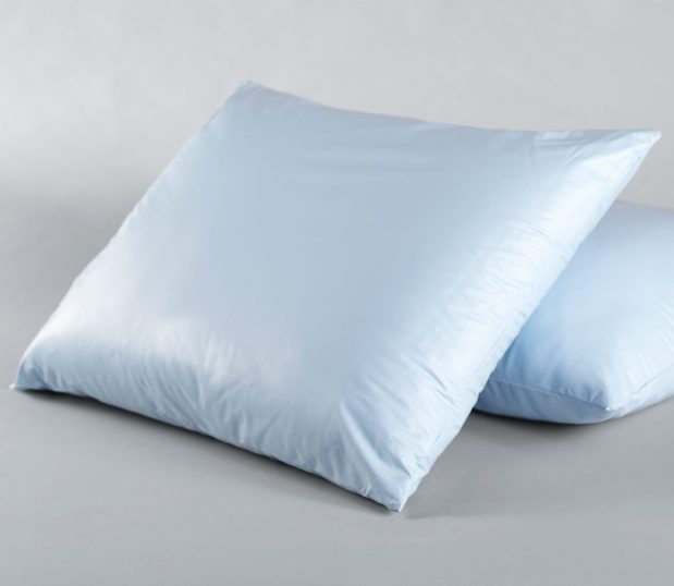 The PerVal® Pillow is a vented hospital pillow with antimicrobial ticking. They are blue and the image shows one being propped up by the second.