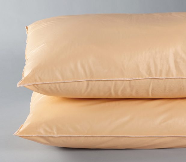 Here are two orange Sonata® Pillows stackd on topof each other. These are affordable bulk hospital pillows.