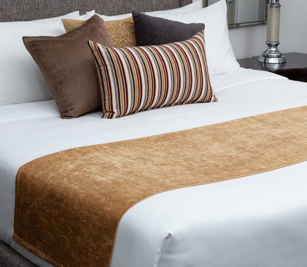 Custom Bed Scarf and pillows in golds and browns on white bed.