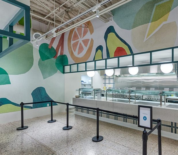 Custom wallcovering in a cafe showing fruit and vegetable graphics.