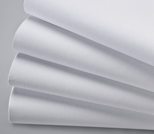 Detail omage of a stack of Centima sheeting. These white, no iron sheets are also stain resistant.