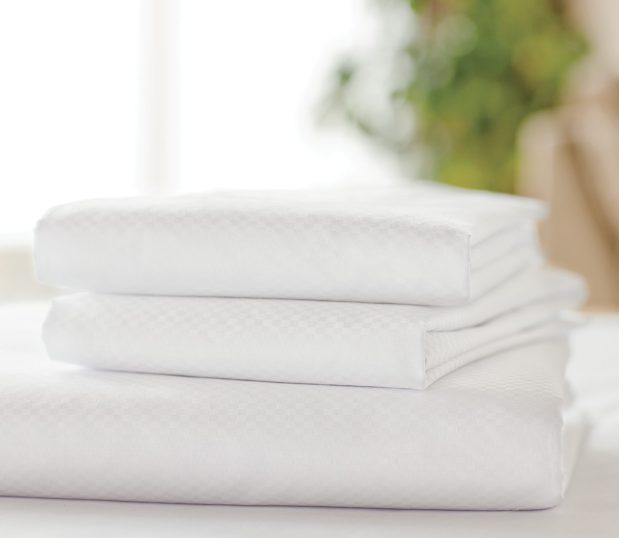 Stack of 5-Star silky smooth sateen sheets. Pattern shown here is the Centium Satin Microcheck.