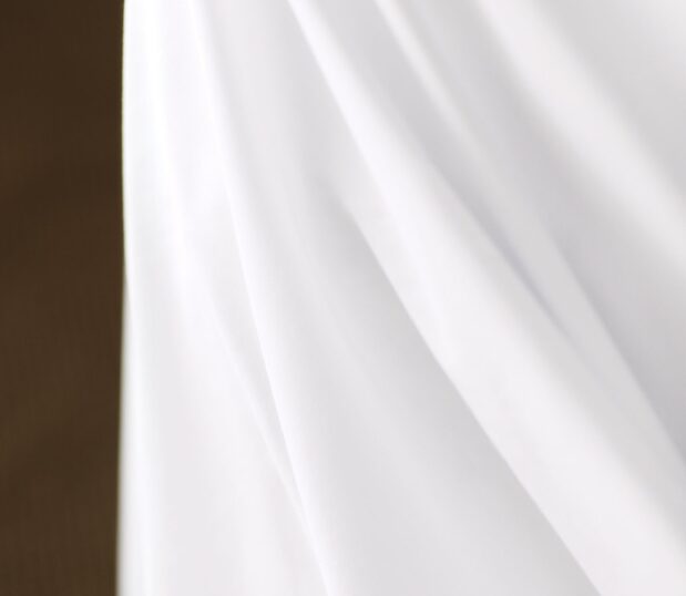 Detail image of Centium Satin Sheets. These sateen sheets have a luxurious hand feel.