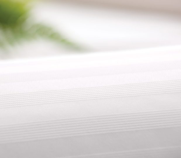 Detail image of white Centium Satin sheets in the Tuxedo Stripe pattern.