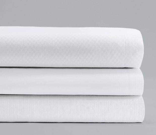 Stack of three ComforTwill sheets in all three patterns: microcheck, tone-on-tone and solid.