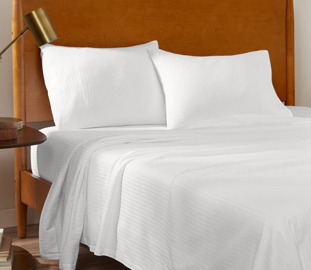 These tough, durable sheets deliver hotel quality comfort. A ComforTwill® sheet will stay bright and soft, wash after wash. Shown here are the white tone-on-tone striped sheeting on a hotel bed.