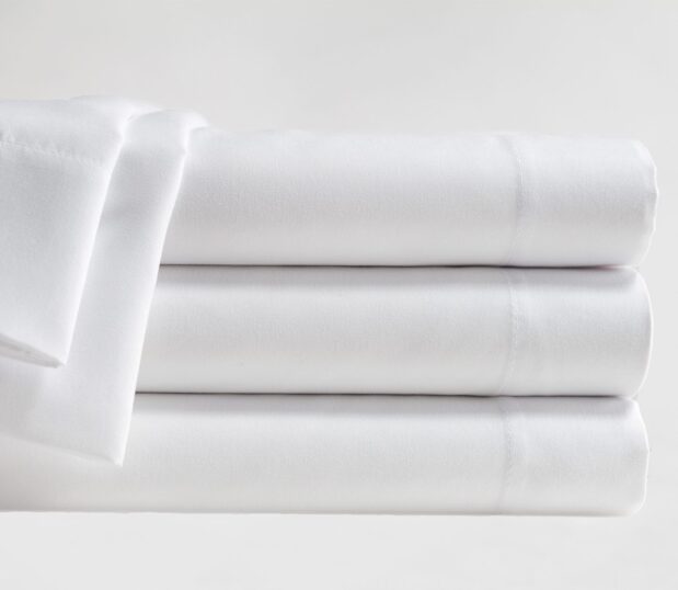 Stack of white Microfiber sheets, These wholesale sheets offer effective performance at an affordable price.