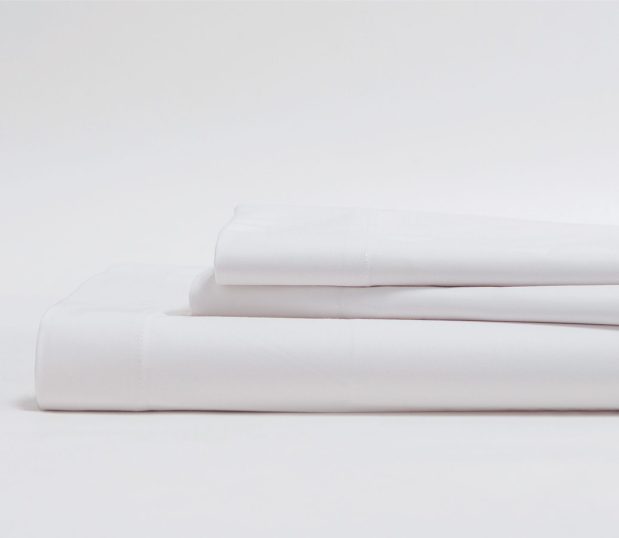 Stack of white T300 sheets. These wholesale sheets offer effective performance at an affordable price.