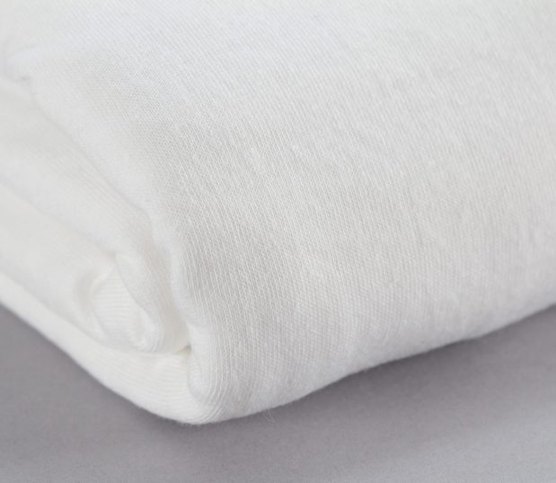 Texturized Fitted Sheets for healthcare facilities featured in the color Bleached white. Detail shot to show texturized fabric.