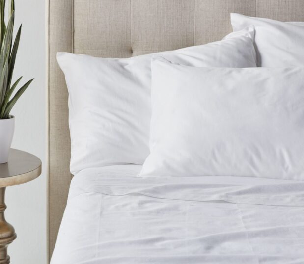 Paragon ™ 100% cotton sheets are made with BCI-certified cotton. These sustainable sheets are a responsible, yet luxuriously comfortable choice. Shown here is a close up image of luxurious Paragon Cotton sheeting and pillowcases on a bed.