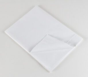 Standard Classic 7030 Woven Sheeting for hospitals and health systems. Available in flat sheet, pillowcase, or drawsheet. Folded flat sheet shown.