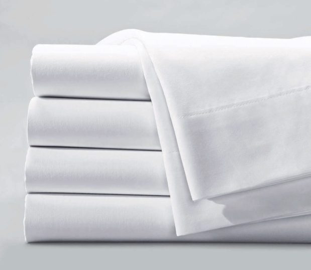 T-180 Woven Sheeting for hospitals and health systems hospital bedding. A folded stack of sheets in the color Bleached White.