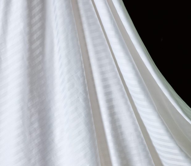 Detail of luxury striped sheets. These T300 sheets feature subtle tone-on-tone stripes.